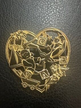 Gold Heart-Shaped Toy Motif Pin